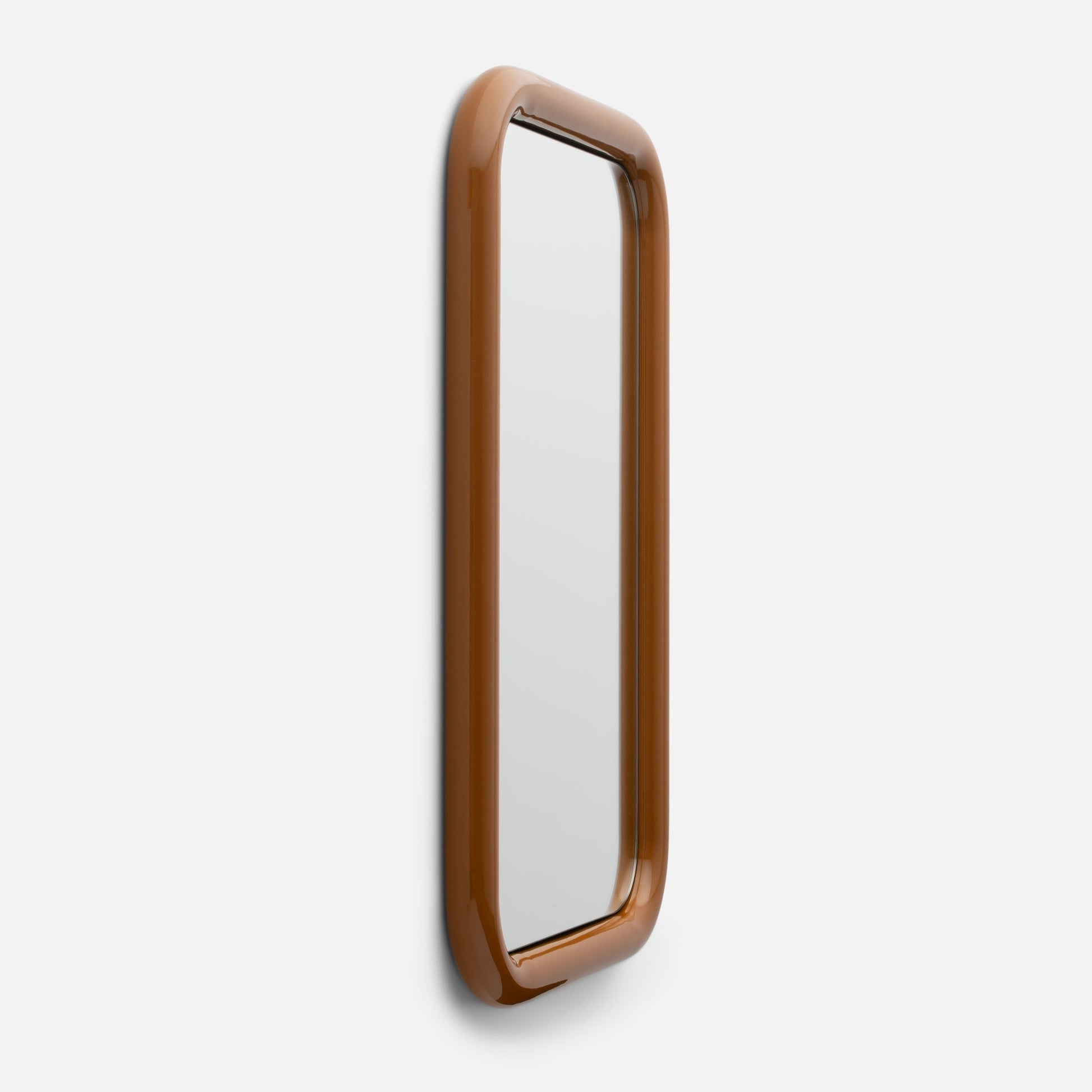 Close-up right-side view of Forma Mirror showcasing glossy rounded brown frame and narrow vertical mirror on white background