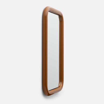 Close-up right-side view of Forma Mirror showcasing glossy rounded brown frame and narrow vertical mirror on white background
