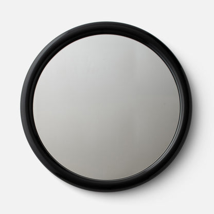 Close-up top view of Forma Mirror showcasing glossy black rounded frame on a white background