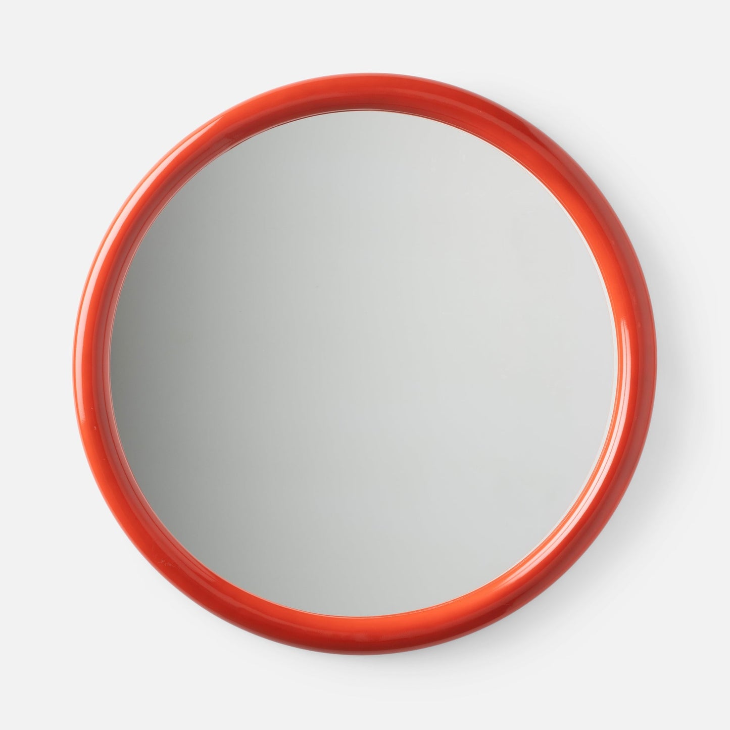 Close-up top view of Forma Mirror showcasing glossy orange-red rounded frame with white background