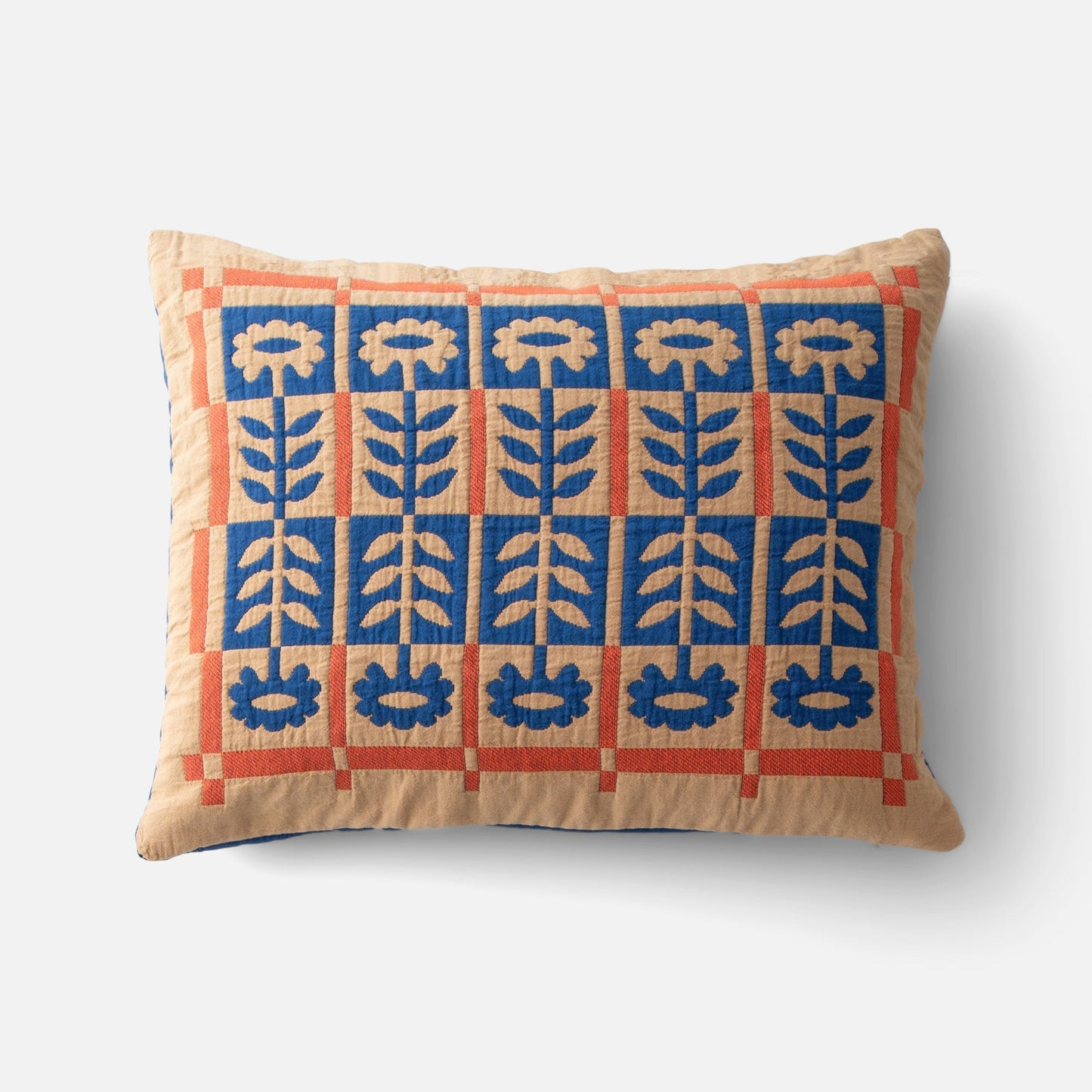 Top view of Stillwater Floral Sham showcasing mirrored blue floral applique and orange grid color blocking on beige background