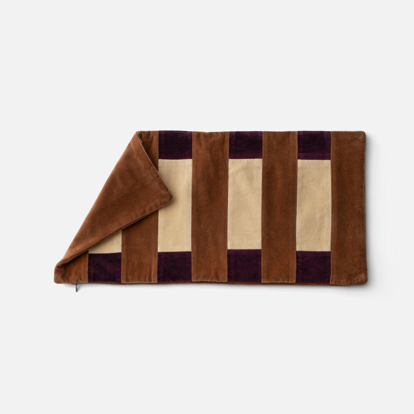 Top-down view of Pieced Velvet Pillow Cover showing folded corner and varsity-style brown and cream velvet stripes with deep purple accents on white background