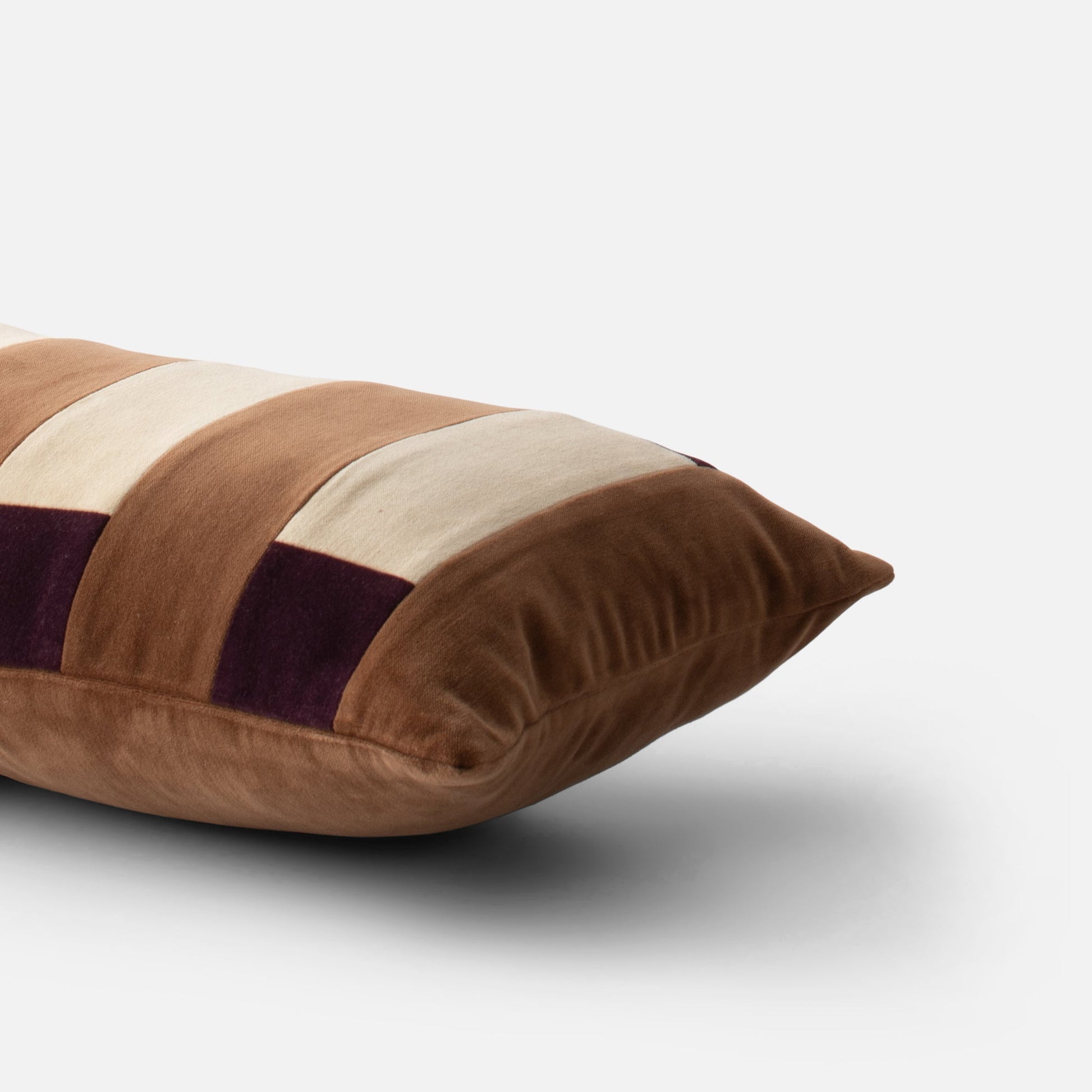 Angled close-up of Pieced Velvet Pillow Cover showing wide varsity-striped cotton velvet texture on white background