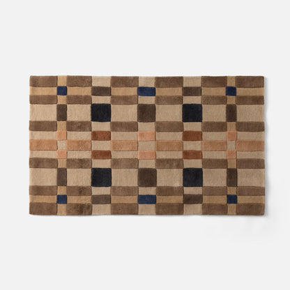 Top-edge view of Campus Wool Rug runner showcasing recessed-pile plaid squares in brown, tan, rust and navy on white background