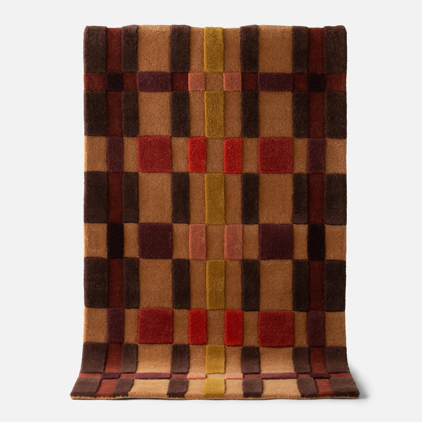 Top view of Campus Wool Rug showing recessed pile and plaid-inspired squares in warm brown, rust, and mustard on a light gray background