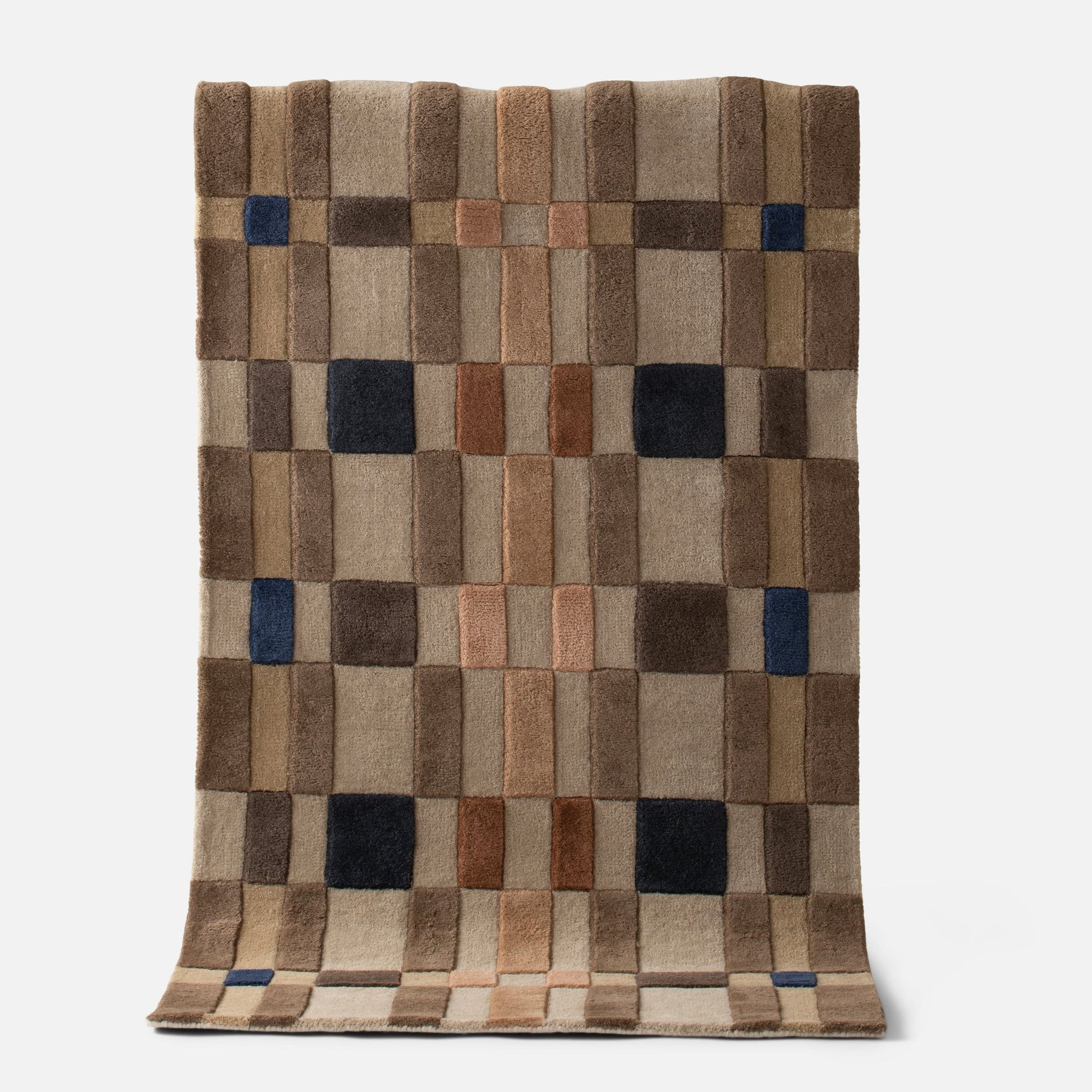 Top view of Campus Wool Rug, recessed pile and plaid-inspired brown grid with navy accent squares on white background