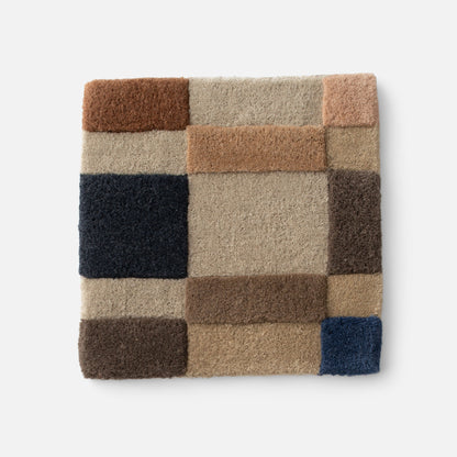 Close-up of Campus Wool Rug showing recessed-pile texture and block plaid in brown, beige, tan and navy