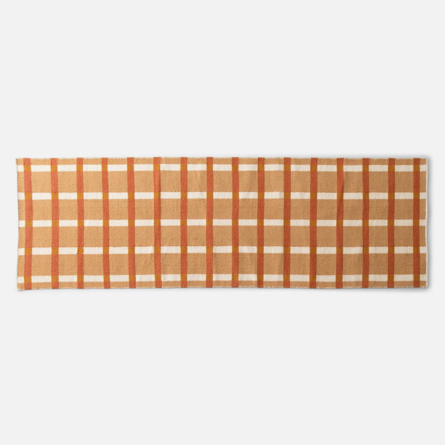 Cropped top edge of Plaid Wool Reversible Rug showing orange, tan, and cream plaid wool weave on white background