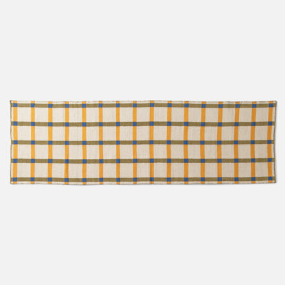 Top-edge view of Plaid Wool Reversible Rug showcasing woven yellow, olive, and blue plaid on a white studio background