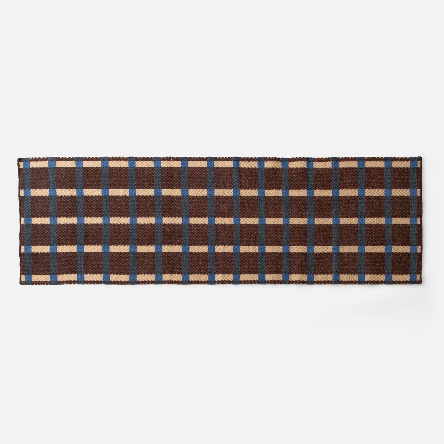Top down view of Plaid Wool Reversible Rug showing brown, blue and cream plaid on white background