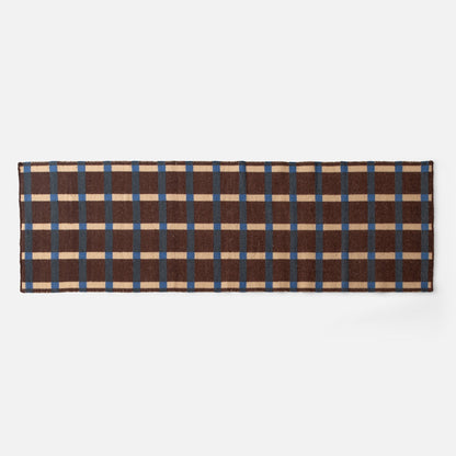 Top down view of Plaid Wool Reversible Rug showing brown, blue and cream plaid on white background