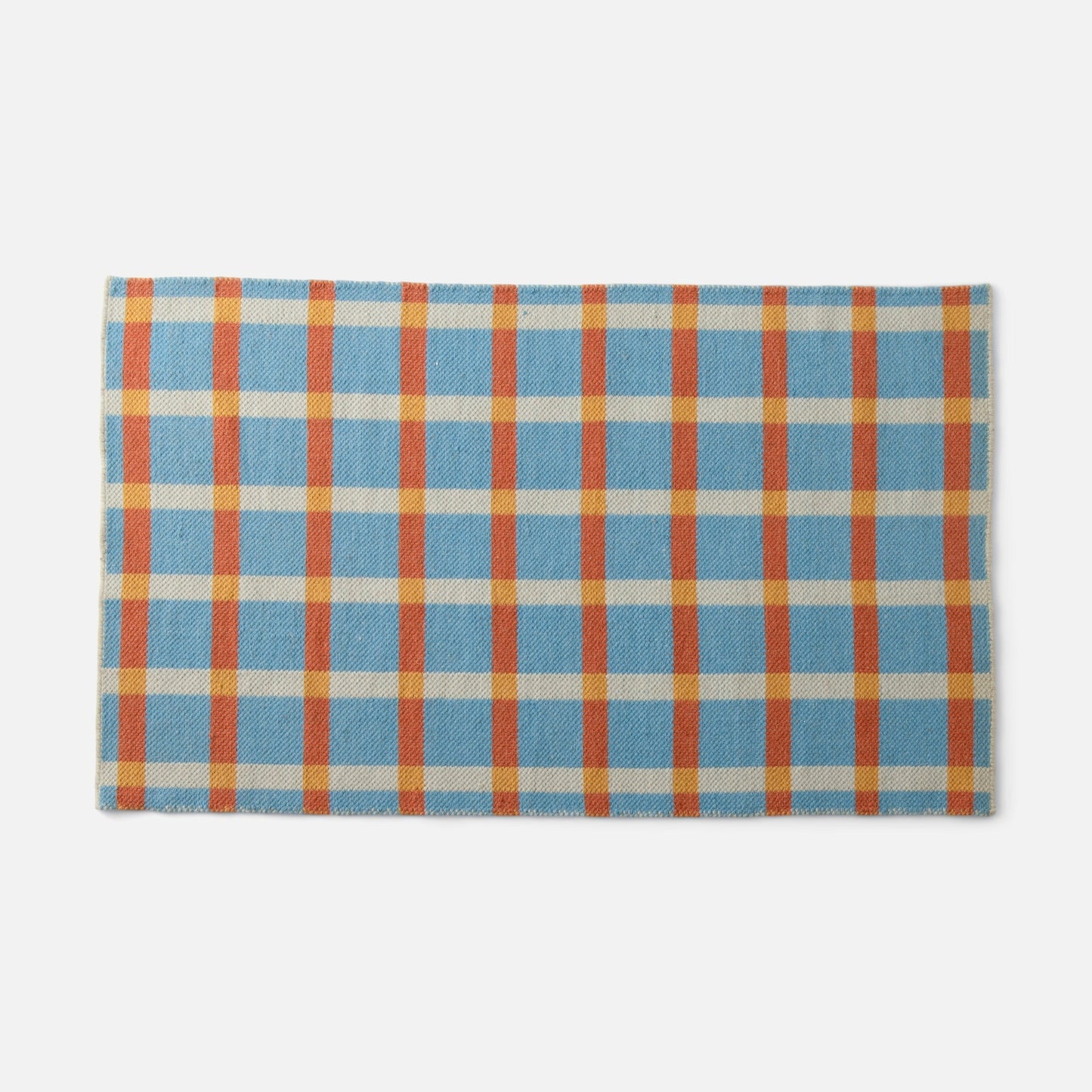 Top edge view of Plaid Wool Reversible Rug showcasing blue cream orange and yellow plaid handwoven texture on white background