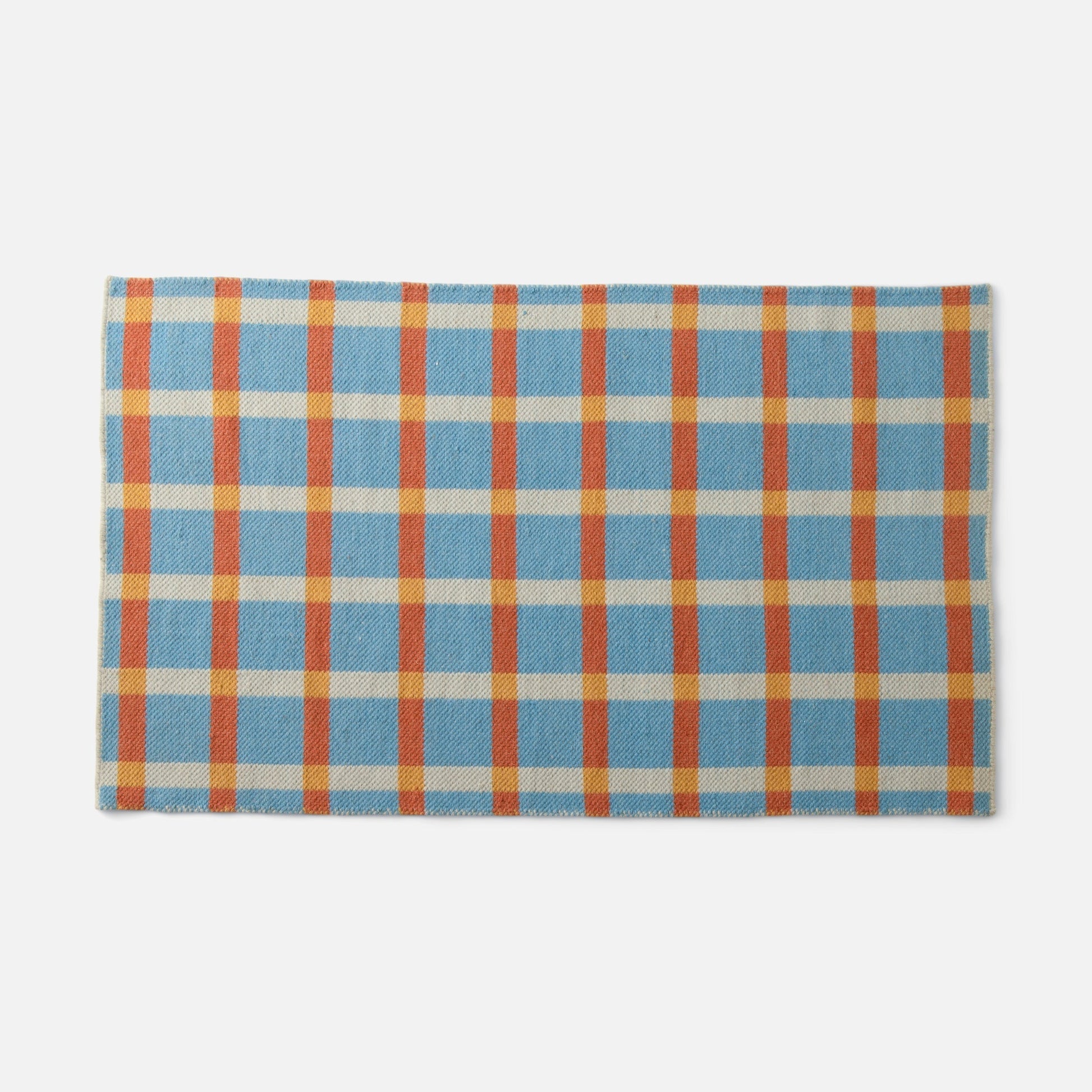 Top edge view of Plaid Wool Reversible Rug showcasing blue cream orange and yellow plaid handwoven texture on white background