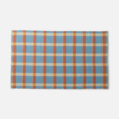 Top edge view of Plaid Wool Reversible Rug showcasing blue cream orange and yellow plaid handwoven texture on white background