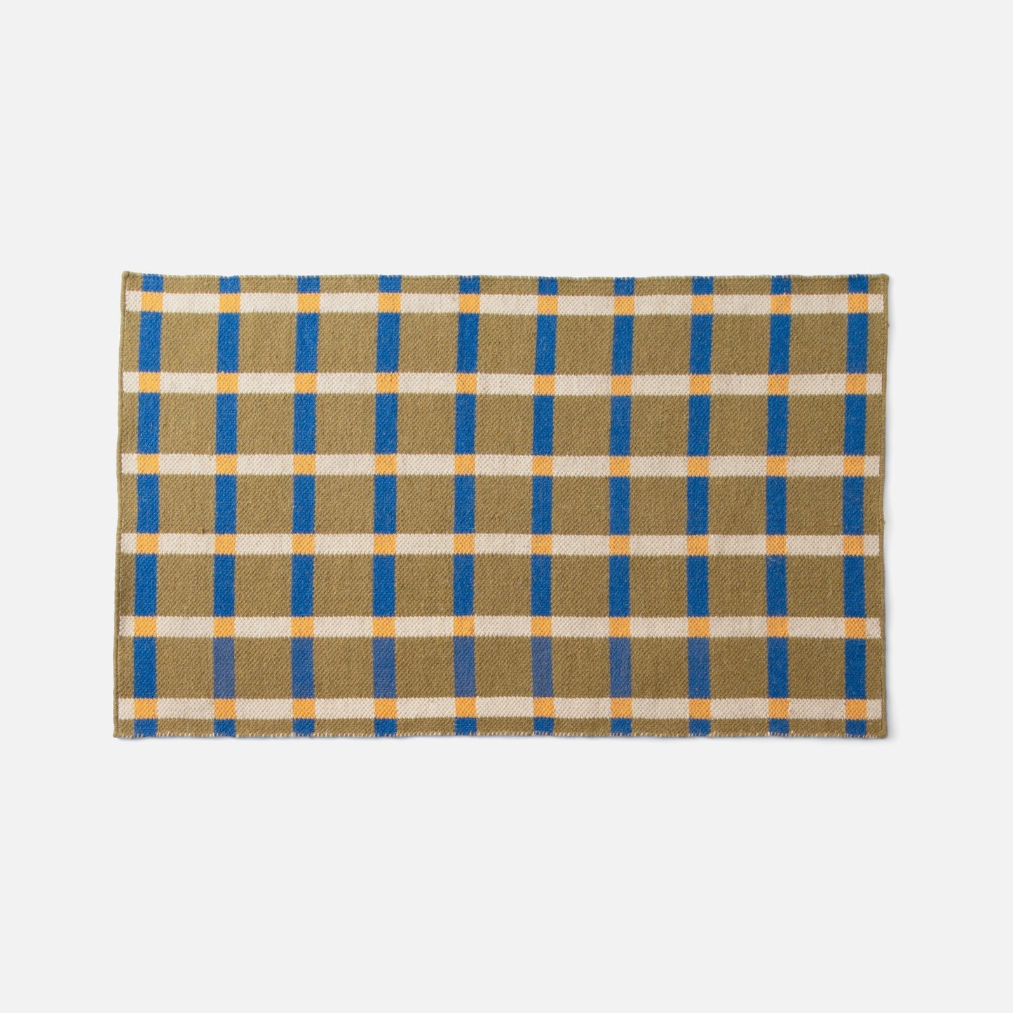 Top-edge view of Plaid Wool Reversible Rug showcasing olive, blue and cream plaid on white background