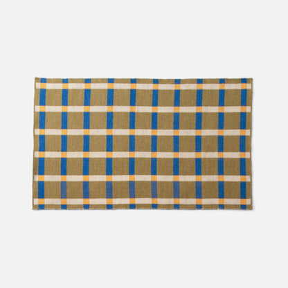 Top-edge view of Plaid Wool Reversible Rug showcasing olive, blue and cream plaid on white background