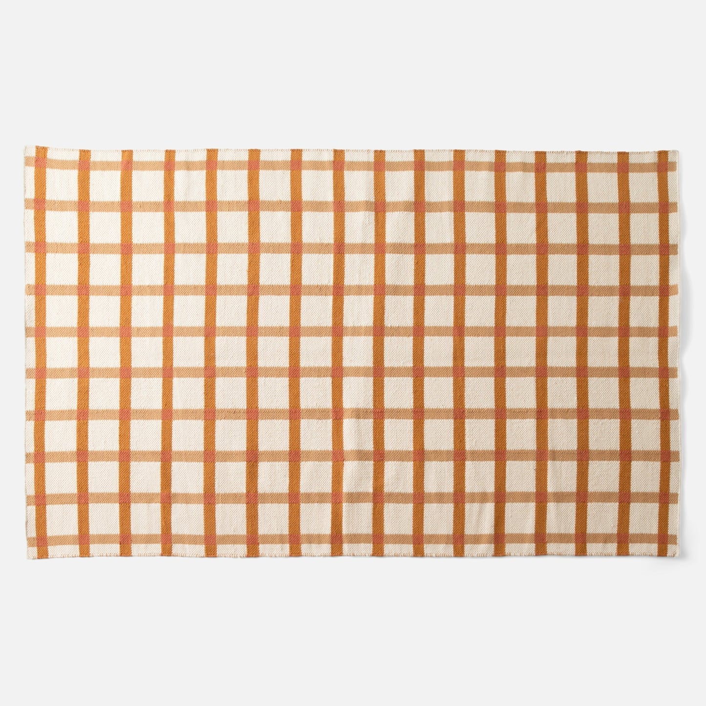 Top view of Plaid Wool Reversible Rug showcasing orange-and-cream plaid pattern and handwoven natural-dyed wool texture on white background