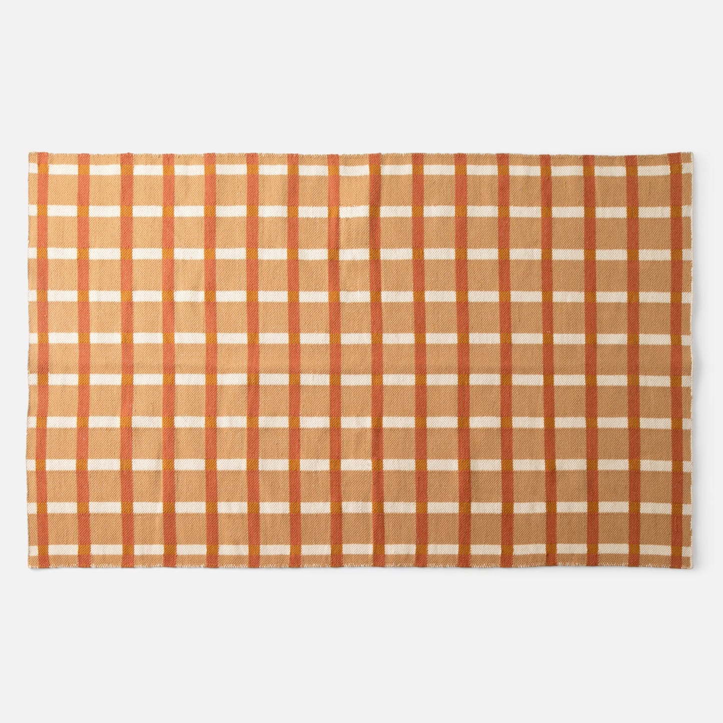 Flat lay of Plaid Wool Reversible Rug showing handwoven natural-dyed wool in orange and tan plaid on white background