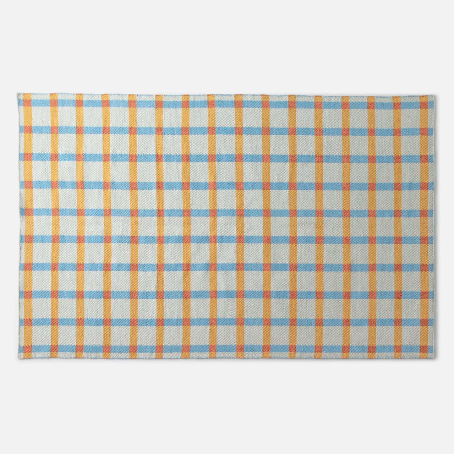 Top-down view of Plaid Wool Reversible Rug showcasing handwoven blue, yellow, and orange plaid on a white background
