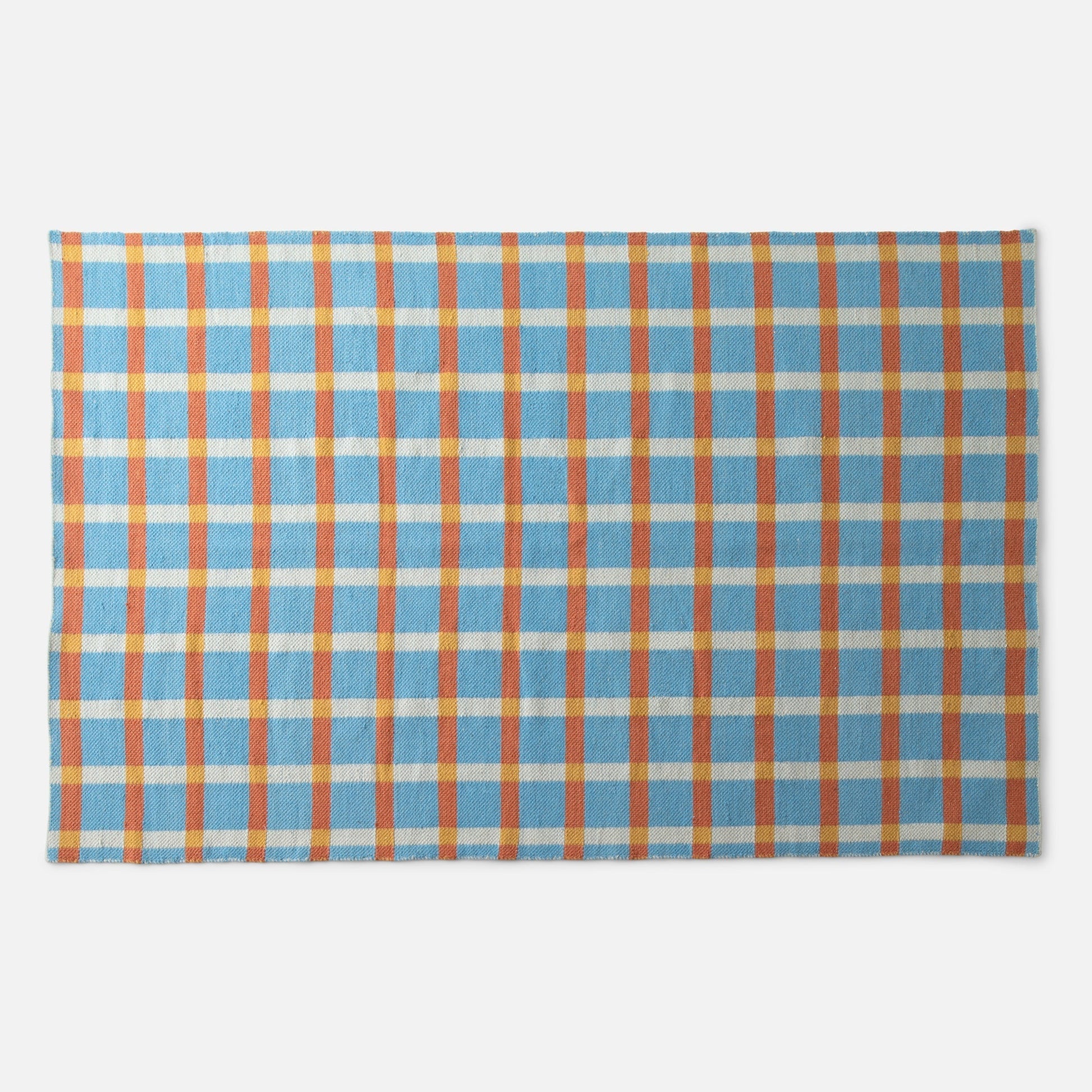 Cropped top view of Plaid Wool Reversible Rug showing blue, orange and yellow plaid wool texture on white background