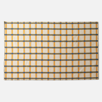 Top-edge view of Plaid Wool Reversible Rug showing cream background with yellow vertical stripes, olive horizontal bands, and blue square intersections