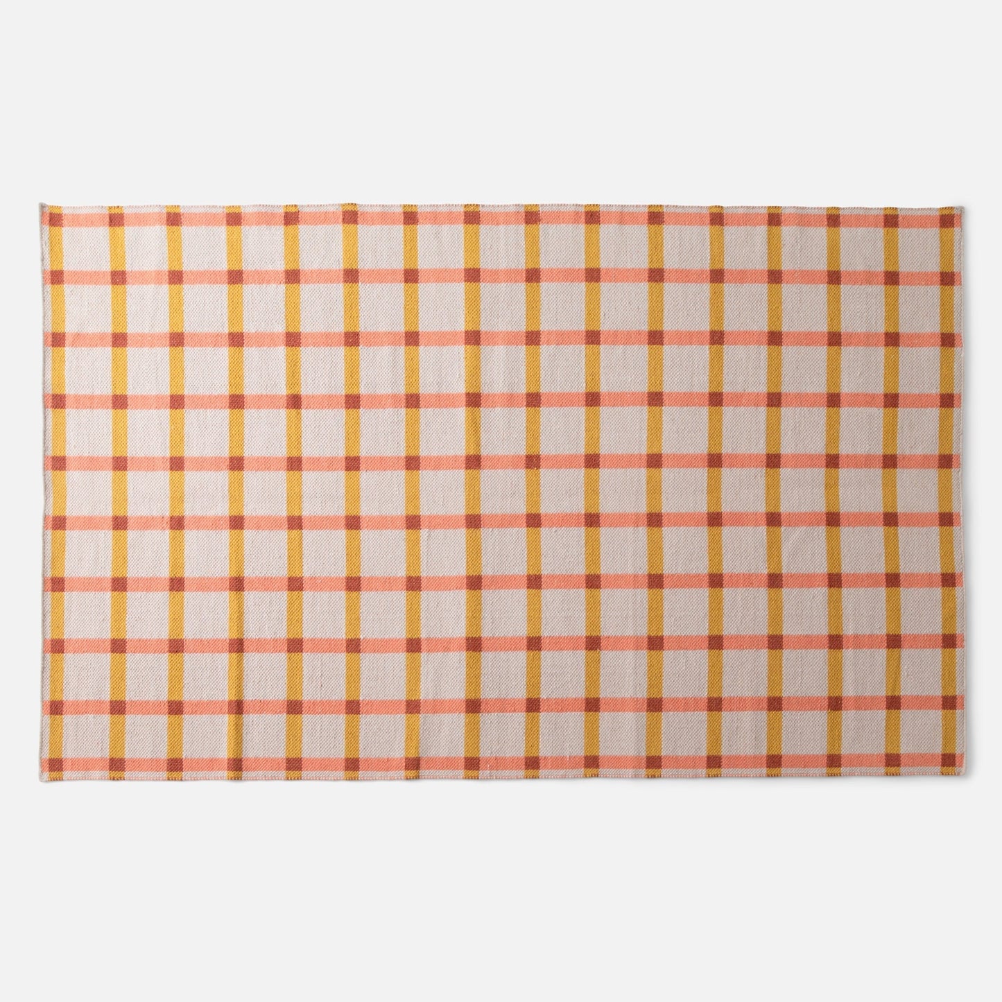Top down view of Plaid Wool Reversible Rug showing handwoven wool texture and bold high contrast plaid on a white background