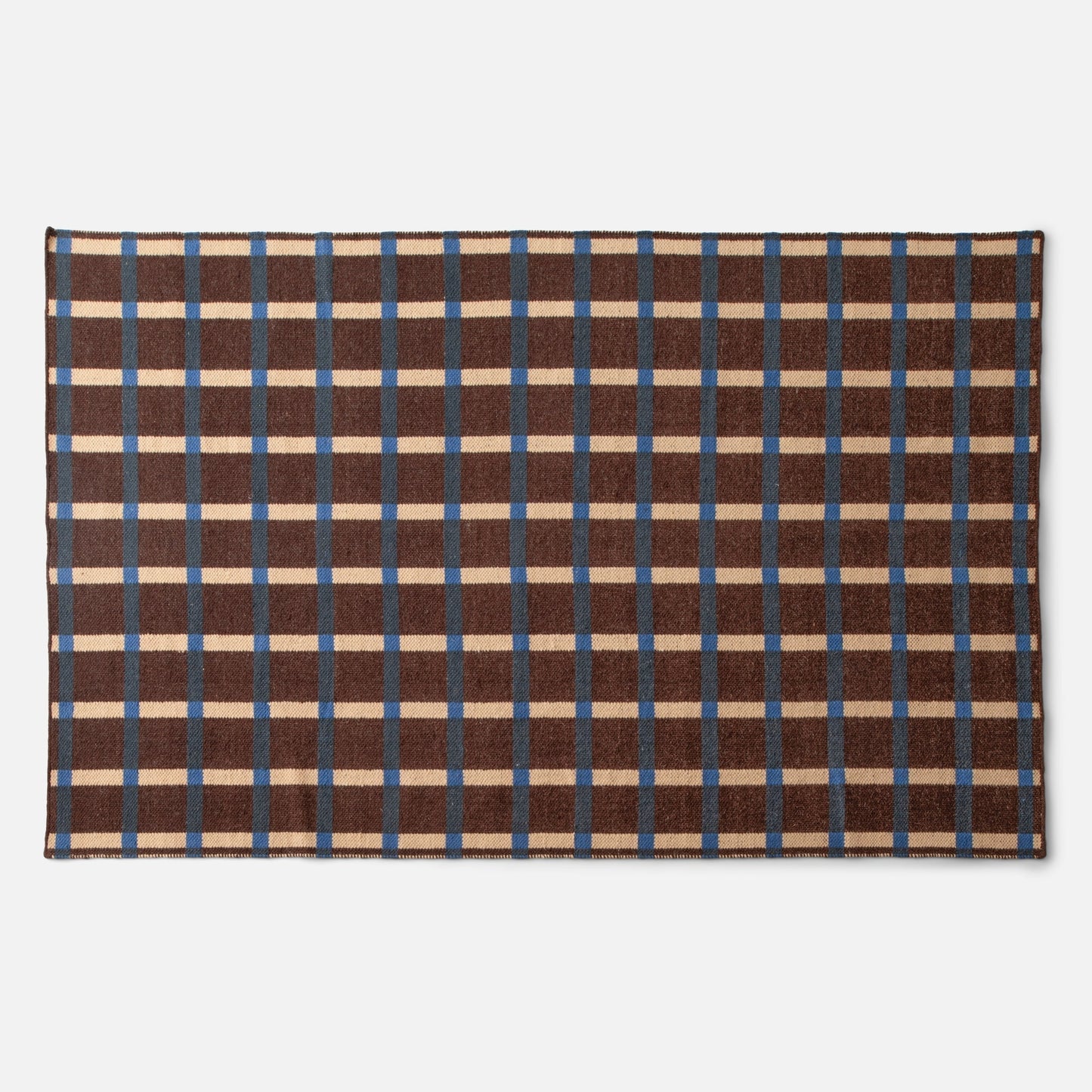 Top view of Plaid Wool Reversible Rug showcasing brown plaid with cream and blue stripes and stitched edge on a white background