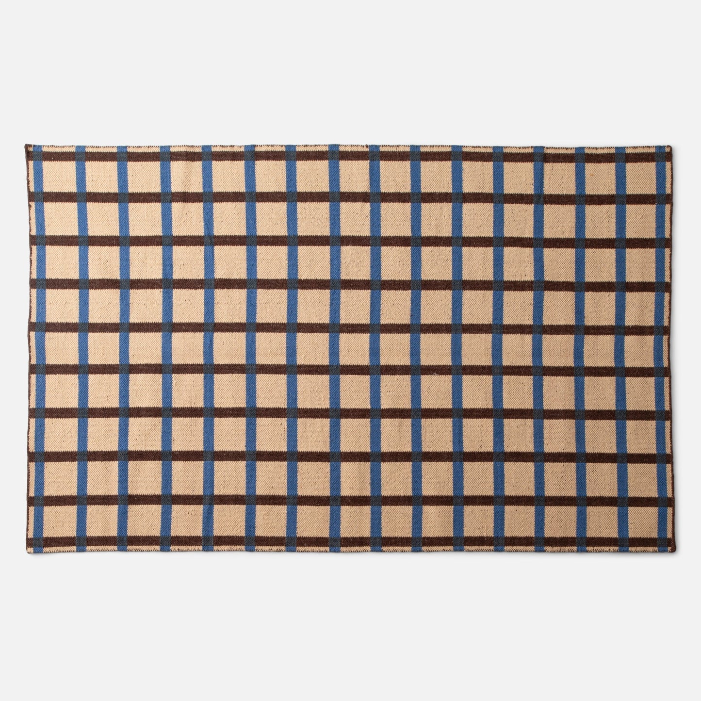 Top-down view of Plaid Wool Reversible Rug showing blue and brown plaid and woven wool texture on white background