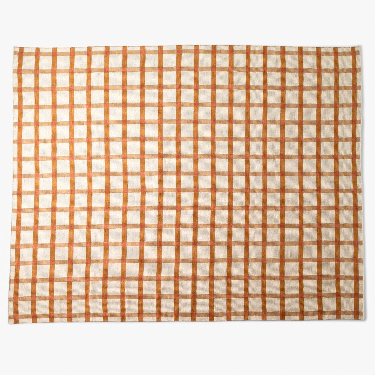 Top-down view of Plaid Wool Reversible Rug showcasing warm orange and tan plaid and woven wool texture on white background