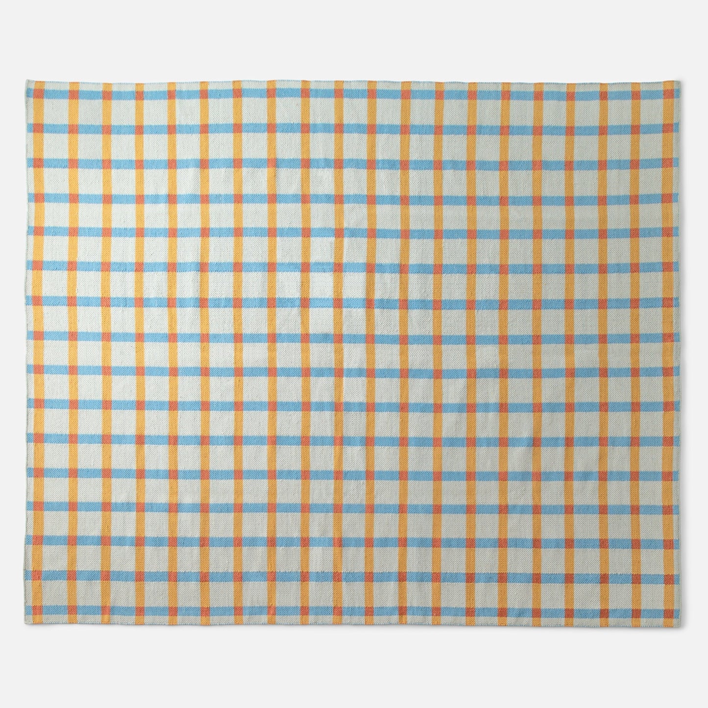 Top view of Plaid Wool Reversible Rug showcasing orange and light blue plaid and handwoven wool texture on a white background