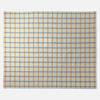Top view of Plaid Wool Reversible Rug showcasing orange and light blue plaid and handwoven wool texture on a white background