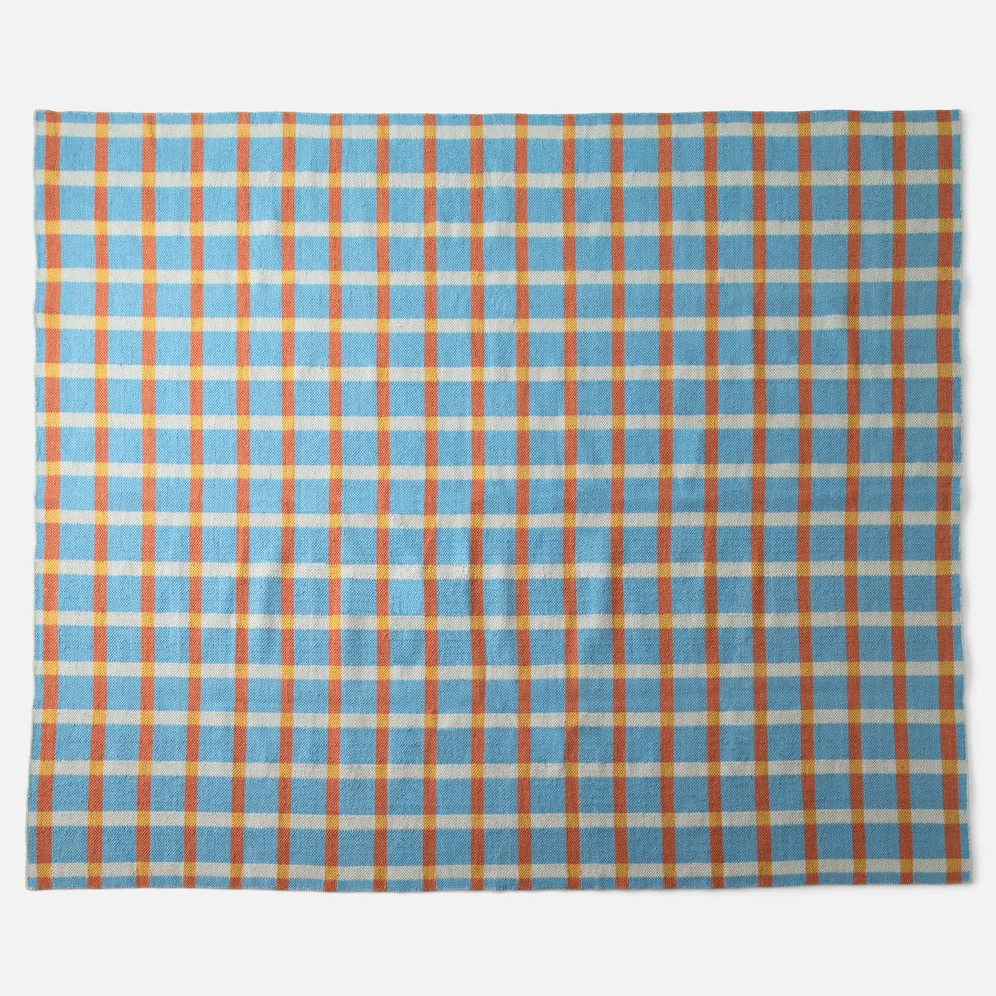 Top-down view of Plaid Wool Reversible Rug showcasing bold plaid pattern and handwoven wool texture on white background
