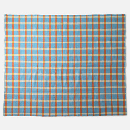 Top-down view of Plaid Wool Reversible Rug showcasing bold plaid pattern and handwoven wool texture on white background