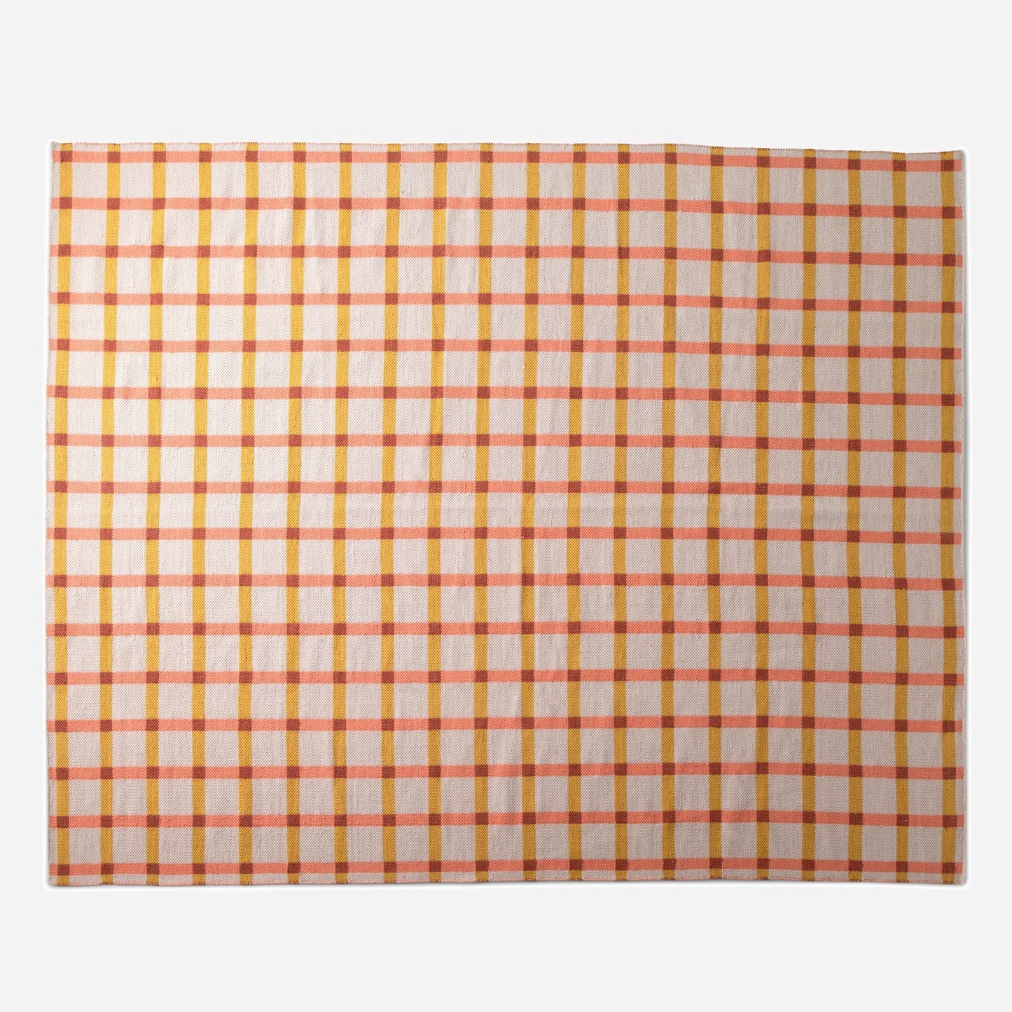 Top-down view of Plaid Wool Reversible Rug showing coral and mustard plaid on a neutral ground with white studio background