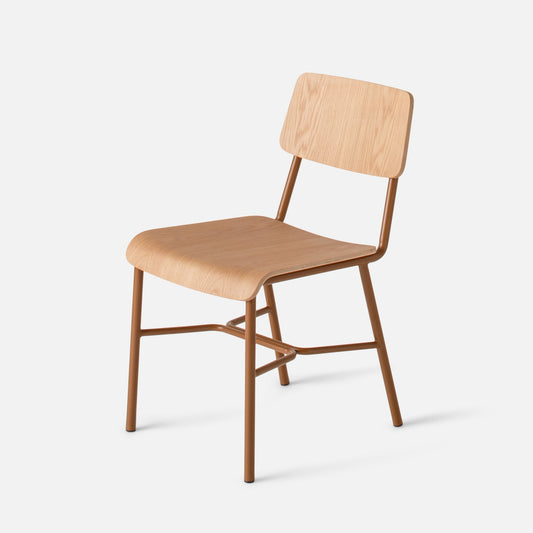 Three-quarter view of Cole Dining Chair showcasing contoured oak veneer seat and backrest with powder-coated metal frame on white background