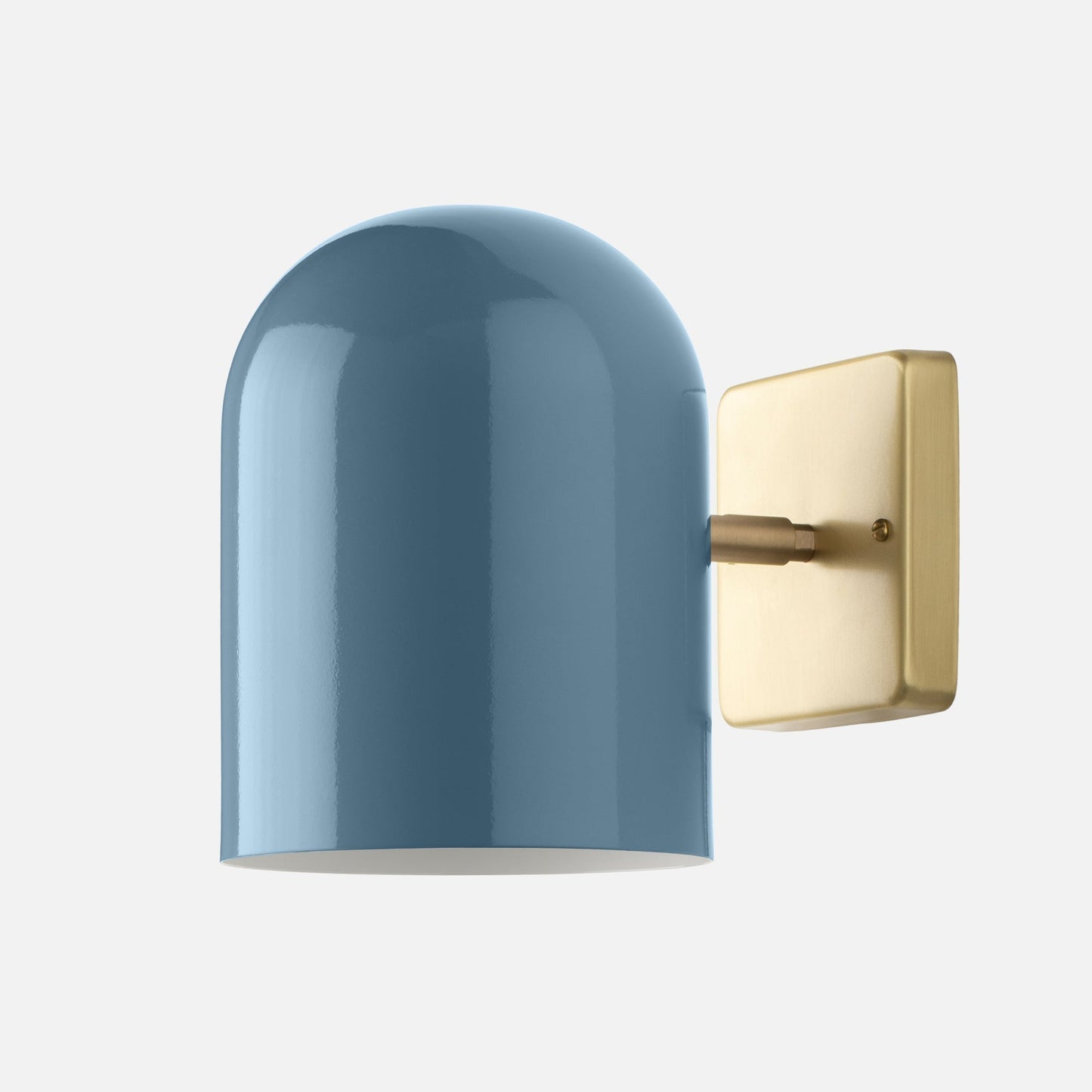 Close-up of Allegheny Wall Sconce showcasing glossy blue shade and natural brass backplate on white background