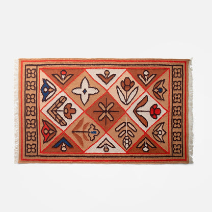 Top-down view of Linnea Wool Flatweave Rug with floral motifs, flatweave texture, and fringed edges on white background