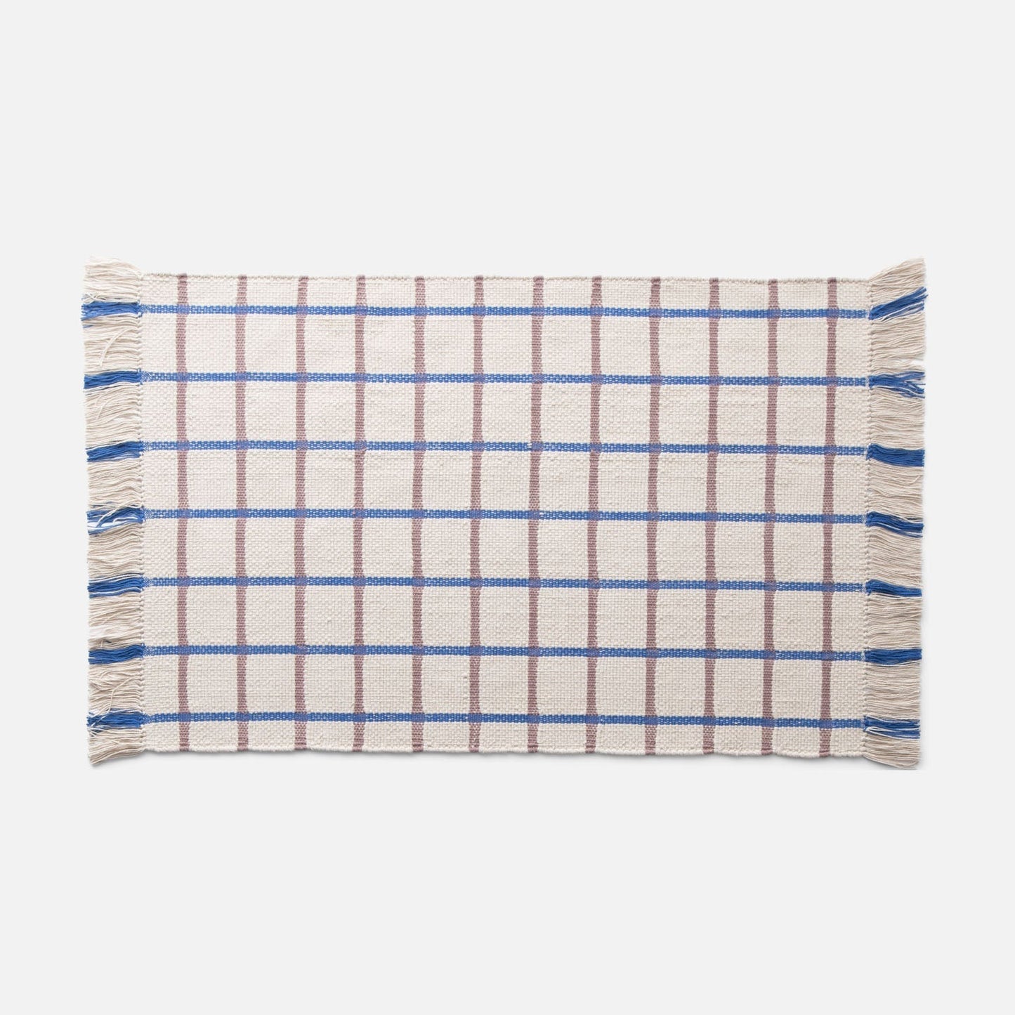 Flat-lay of Cotton Grid Flatweave Rug showcasing blue and brown large grid pattern and fringed ends on a white background