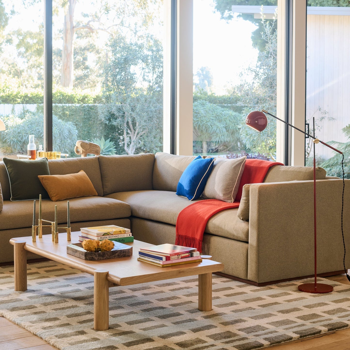 Sunlit living room with Network Tufted Wool Rug in blue high pile geometric pattern under a sectional sofa and coffee table