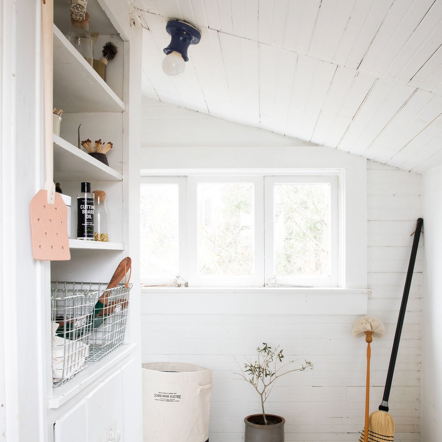Alabax small flush mount on a sloped white beadboard ceiling above a bright utility room window