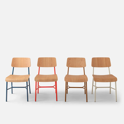 Front view of four Cole Dining Chairs with contoured oak seats and colored powder-coated frames on a light gray background