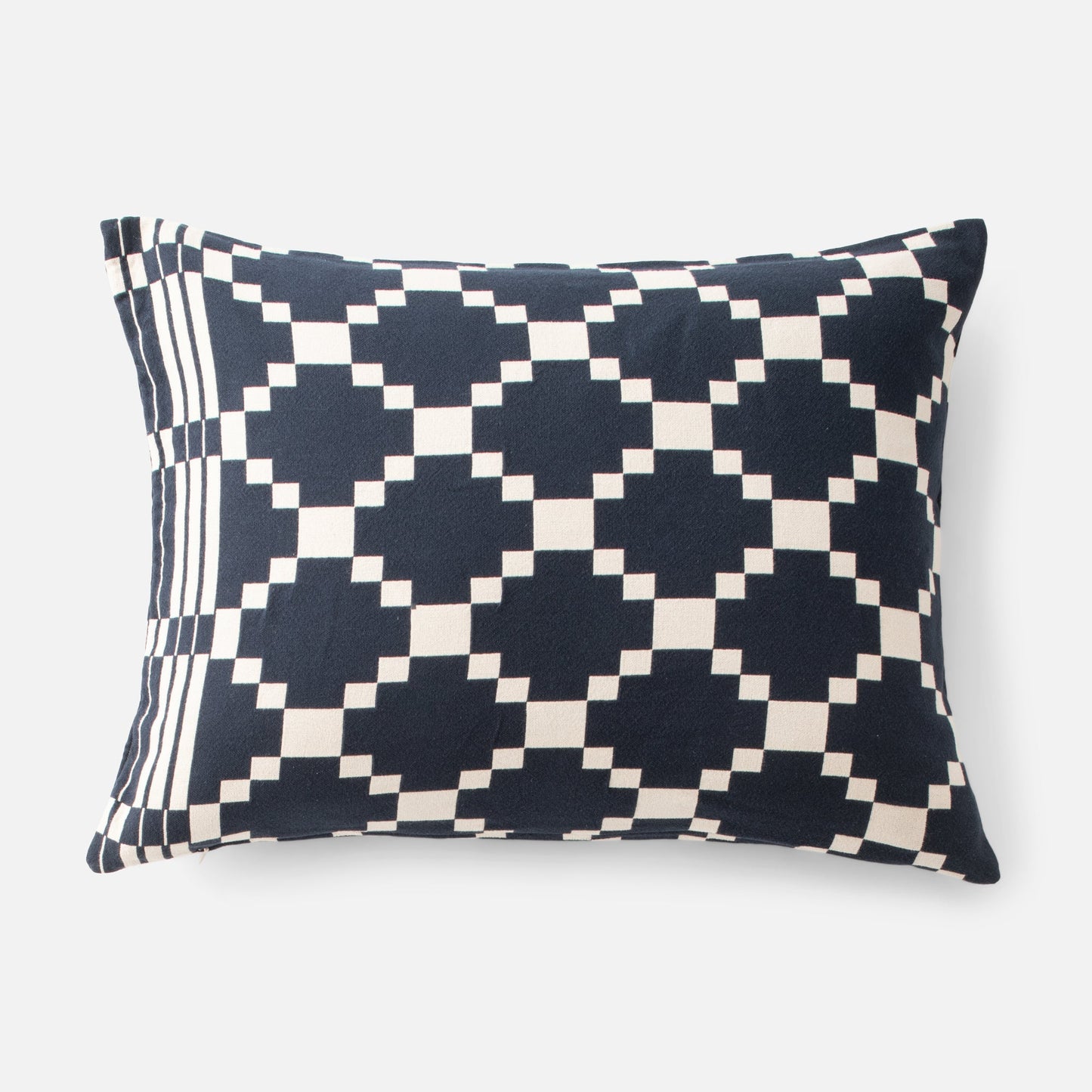 Front view of Winter and Summer Cotton pillow sham with navy-and-cream check and striped left edge on gray background