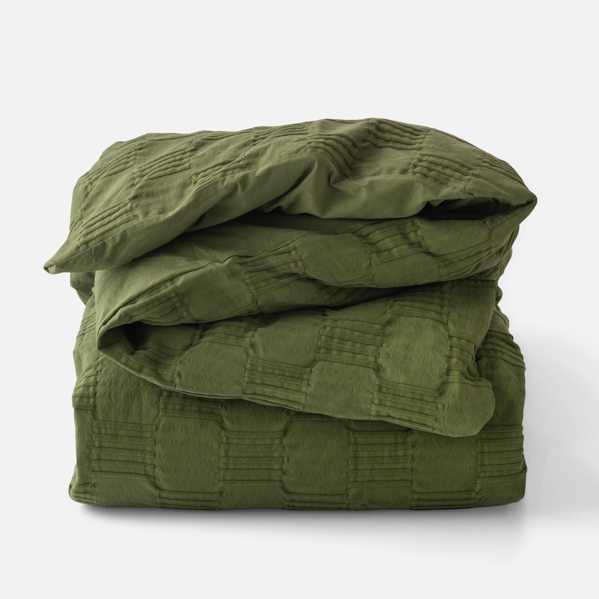 Folded view of Woven Tally Duvet Cover showing stitched grid texture in alder green on white background