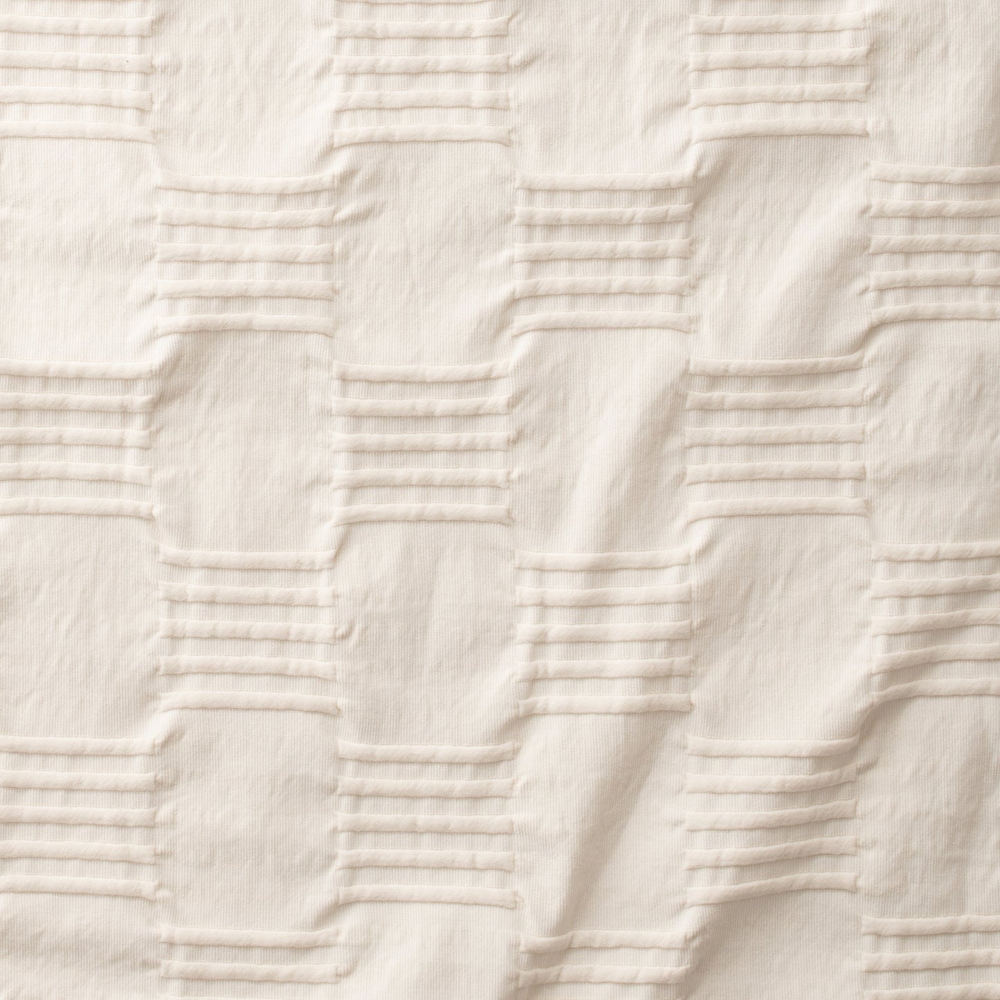 Close-up of Woven Tally Duvet Cover showcasing natural-colored woven pintuck stripes and ribbed texture