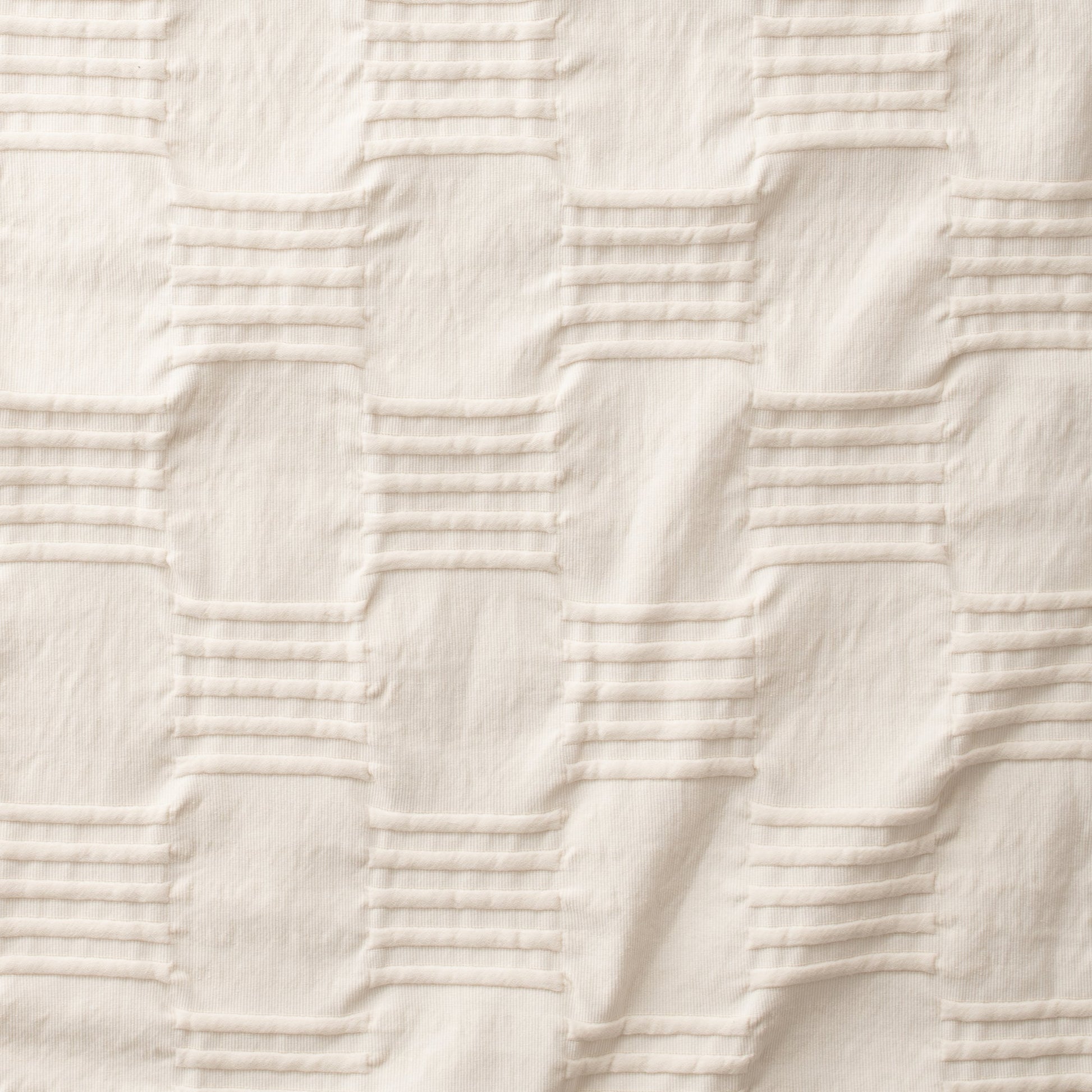 Close-up of Woven Tally Duvet Cover showcasing natural-colored woven pintuck stripes and ribbed texture