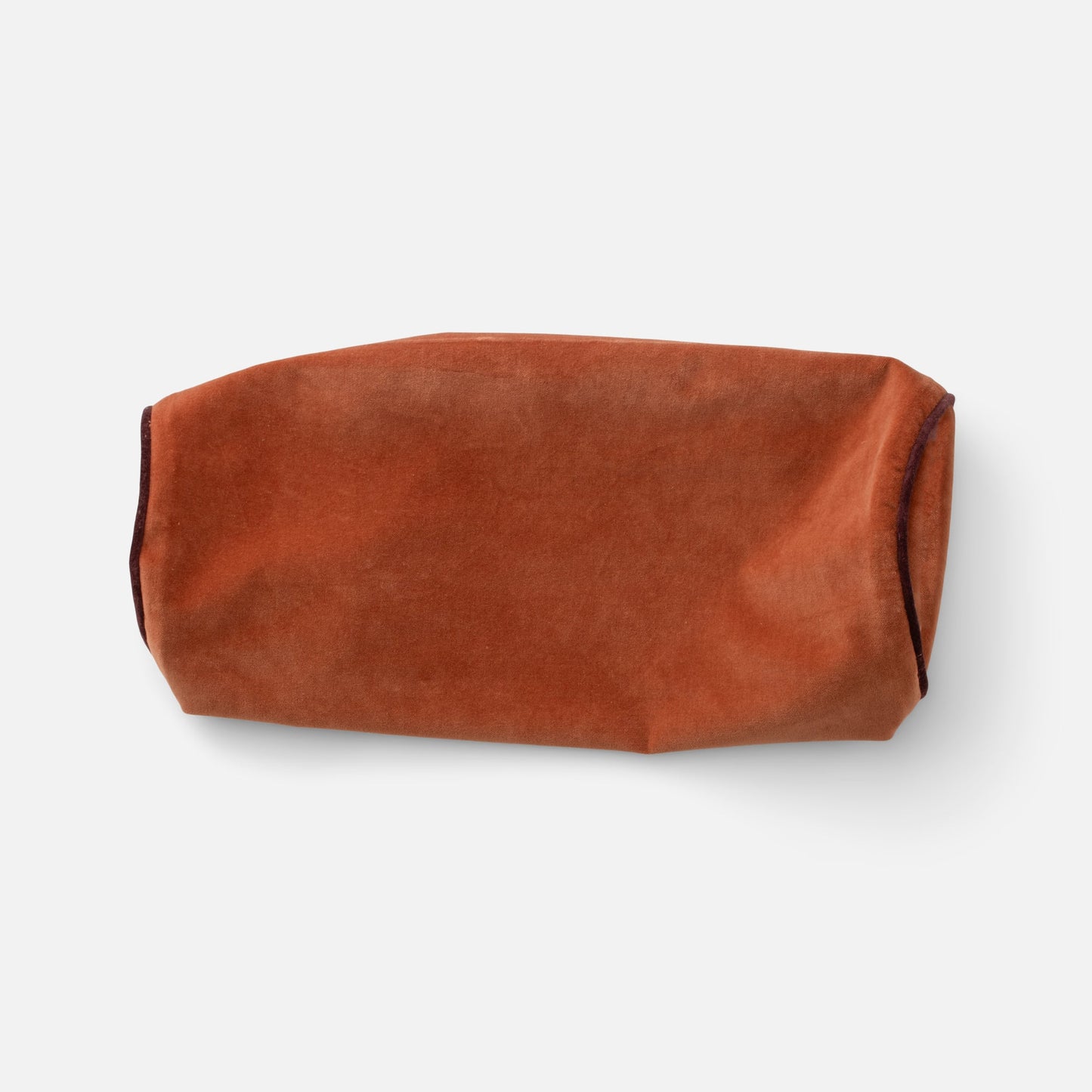 Cropped top view of Velvet Piped Pillow showcasing velvet fabric and contrast piping on white background