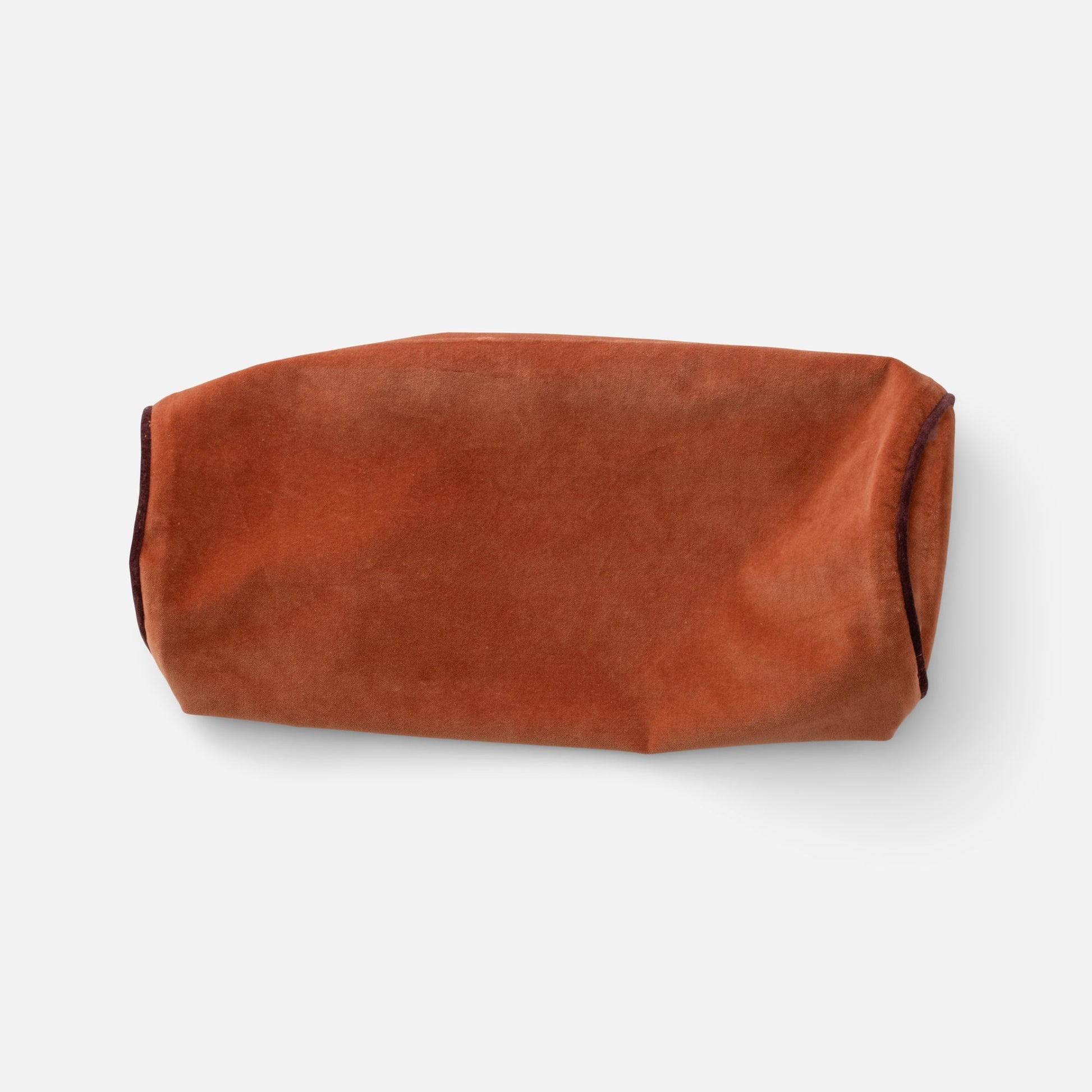 Cropped top view of Velvet Piped Pillow showcasing velvet fabric and contrast piping on white background