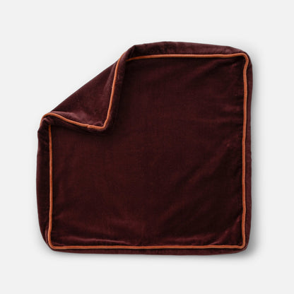 Overhead view of Velvet Piped Pillow showcasing square shape, luxe velvet fabric, and contrast piping on a light gray background