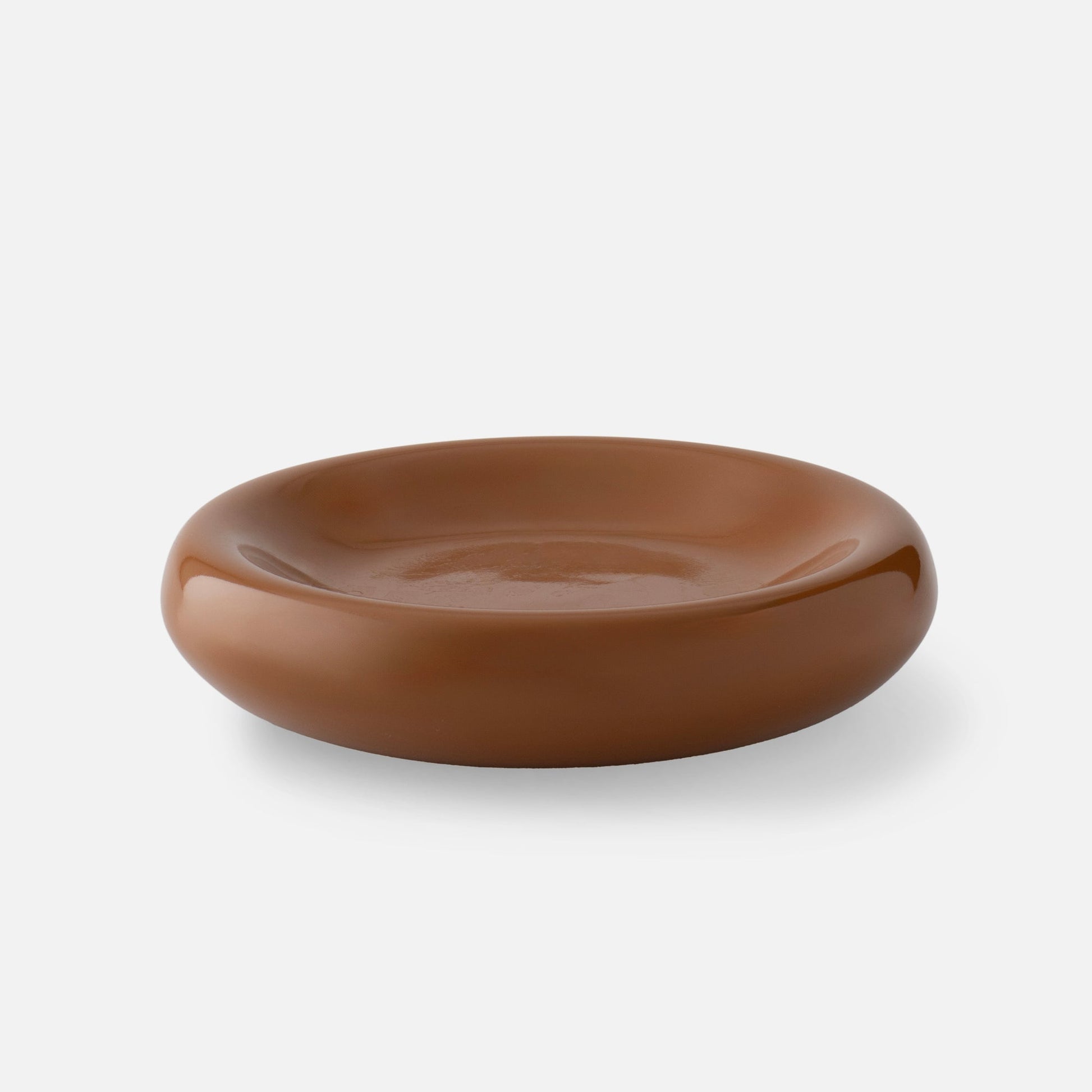 Top view of Yves cast metal catch-all in Raisin Gloss showcasing its shallow concave shape and glossy finish on a white background
