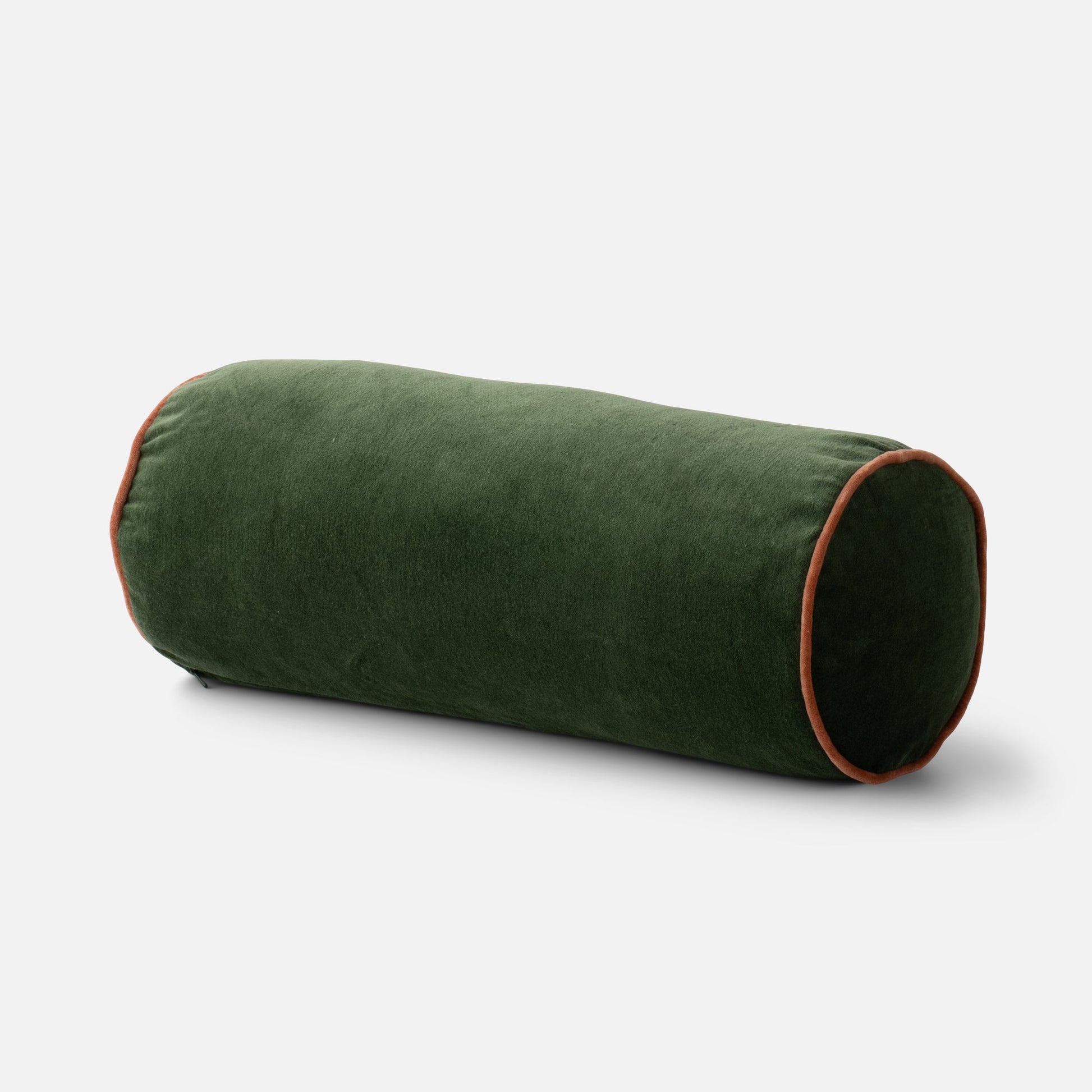 Close up of Velvet Piped Pillow bolster showing 100 percent cotton green velvet and rust piping on light gray background